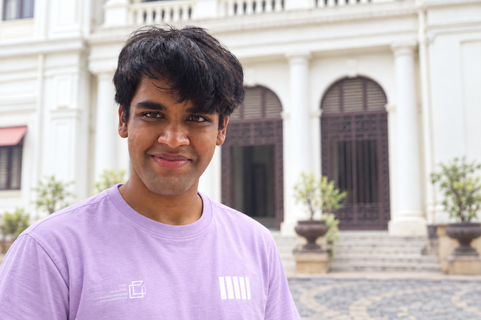 Editorial portrait of Nitesh in front of pale historic architecture